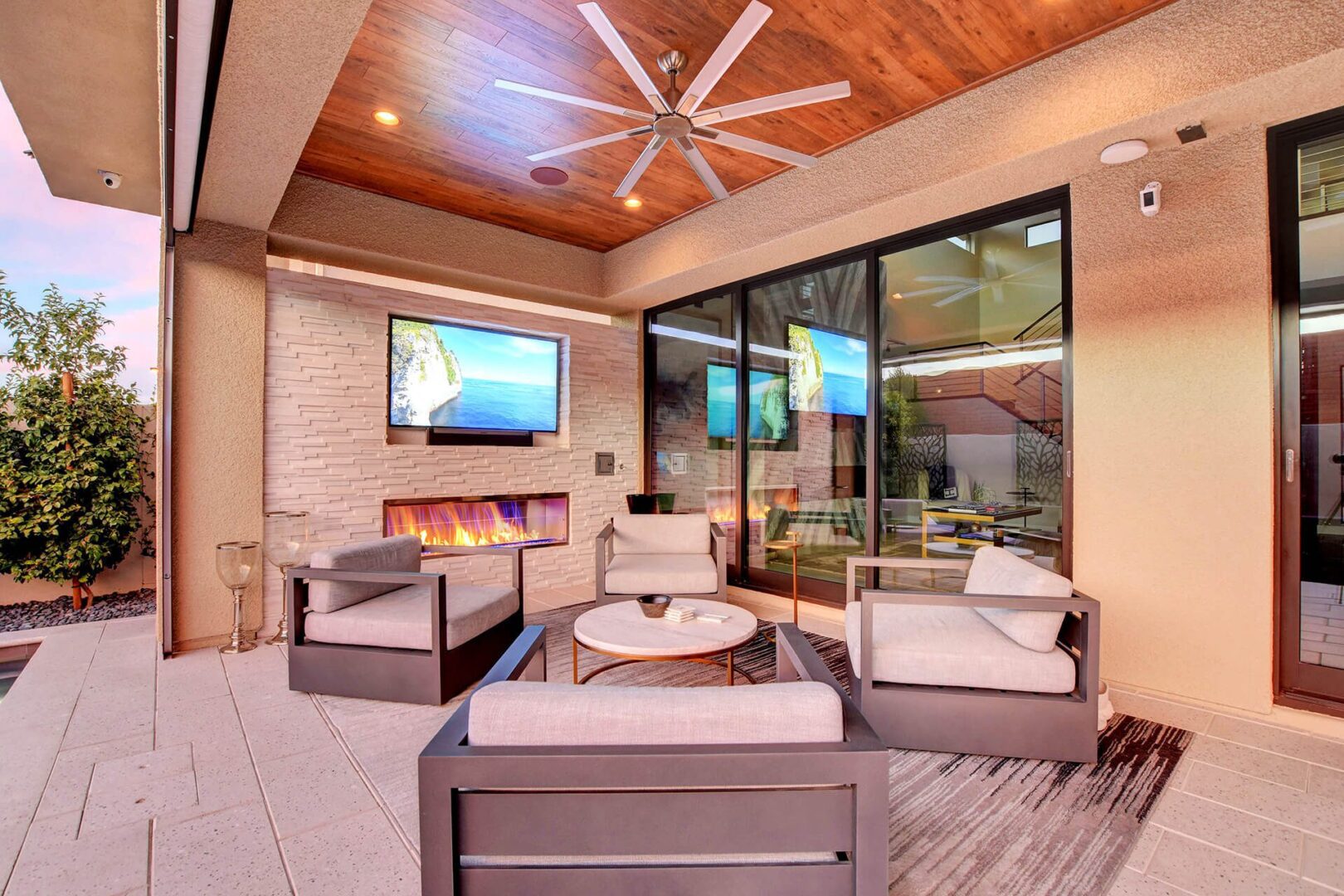 Custom Outdoor Fireplace and Media Wall with recessed flat-screen TV by Custom Outdoor Living of Las Vegas, Nevada