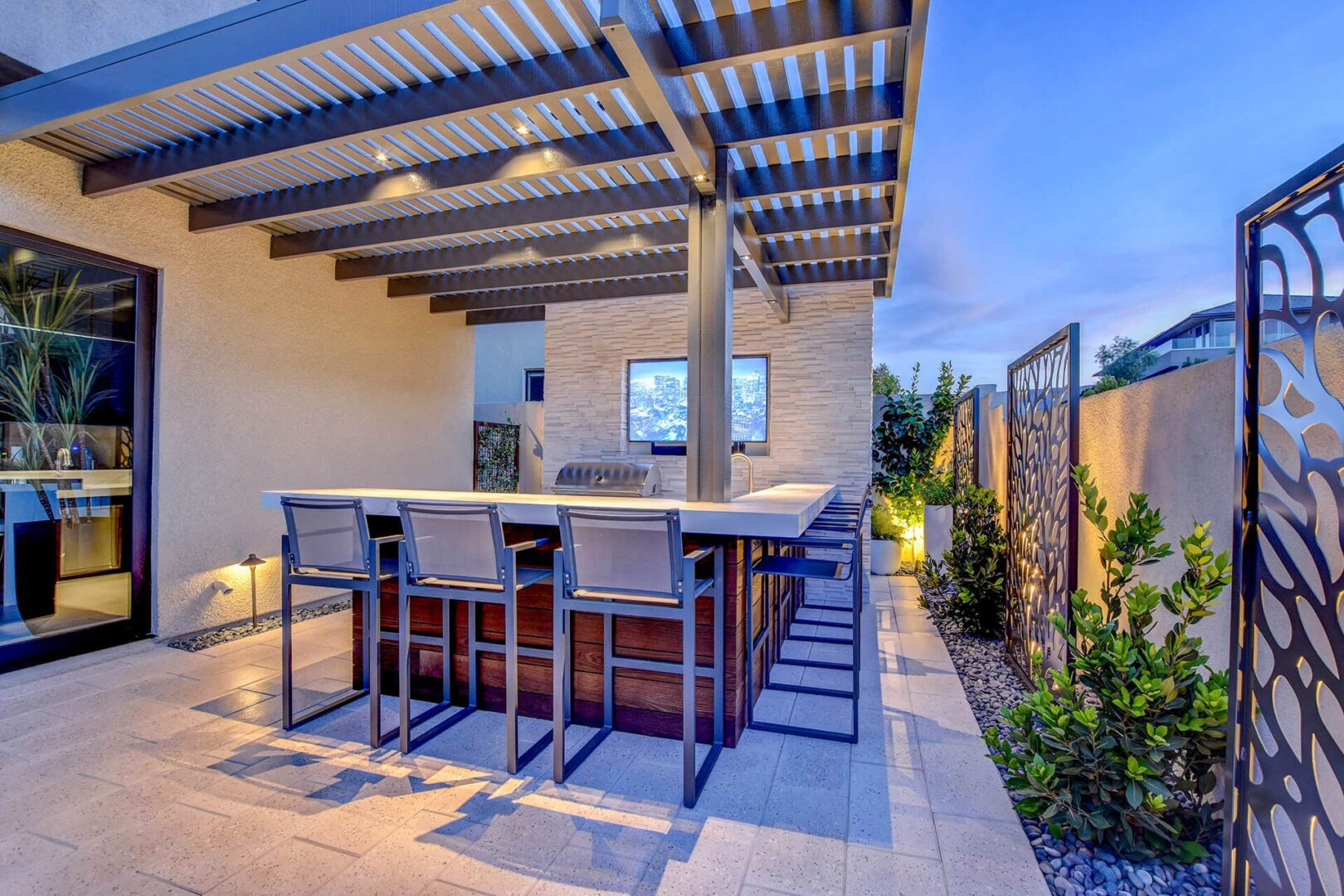 A patio with an outdoor bar and seating area.