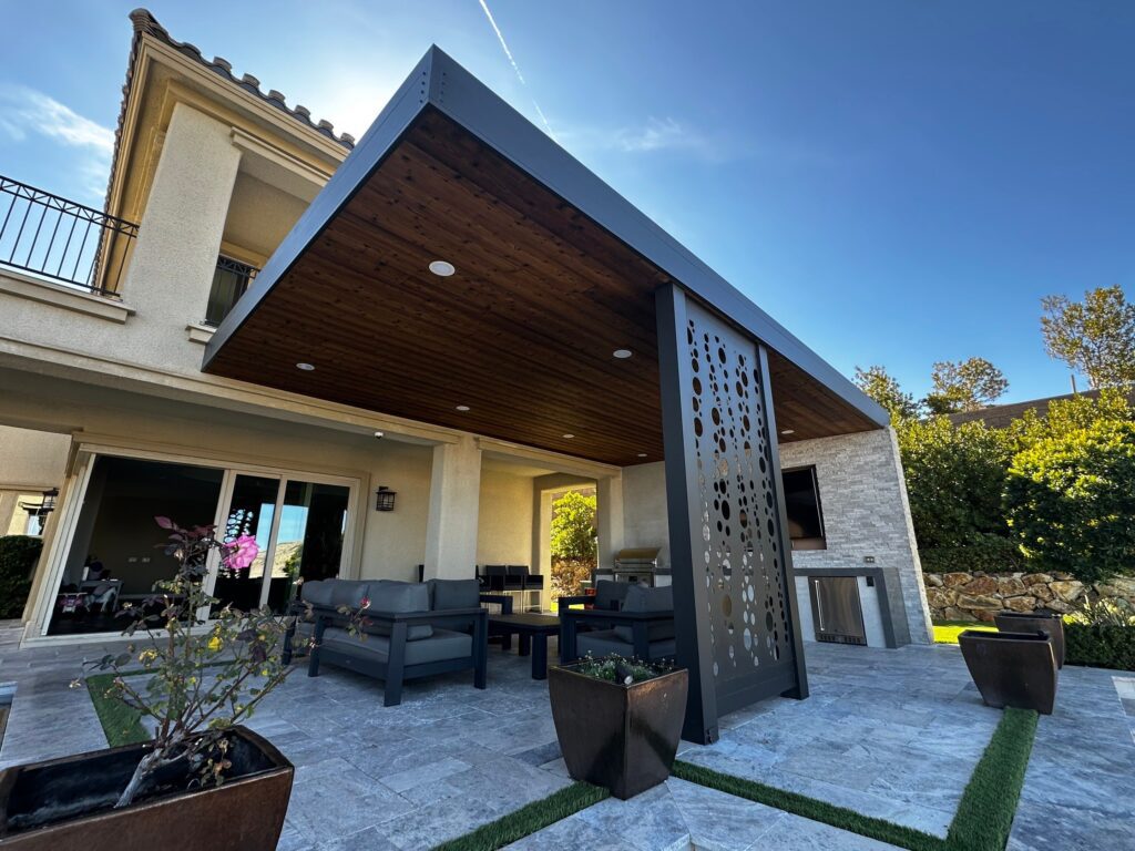 Modern covered patio with wooden ceiling and seating