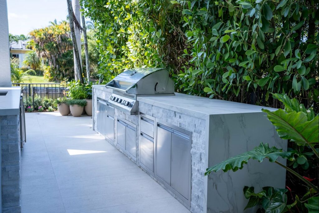 Patio built-in stainless steel grill with greenery