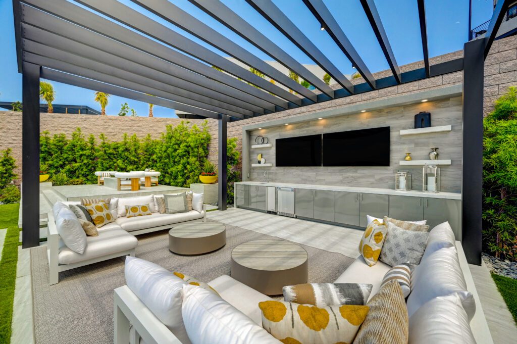 Modern outdoor lounge under pergola with TV